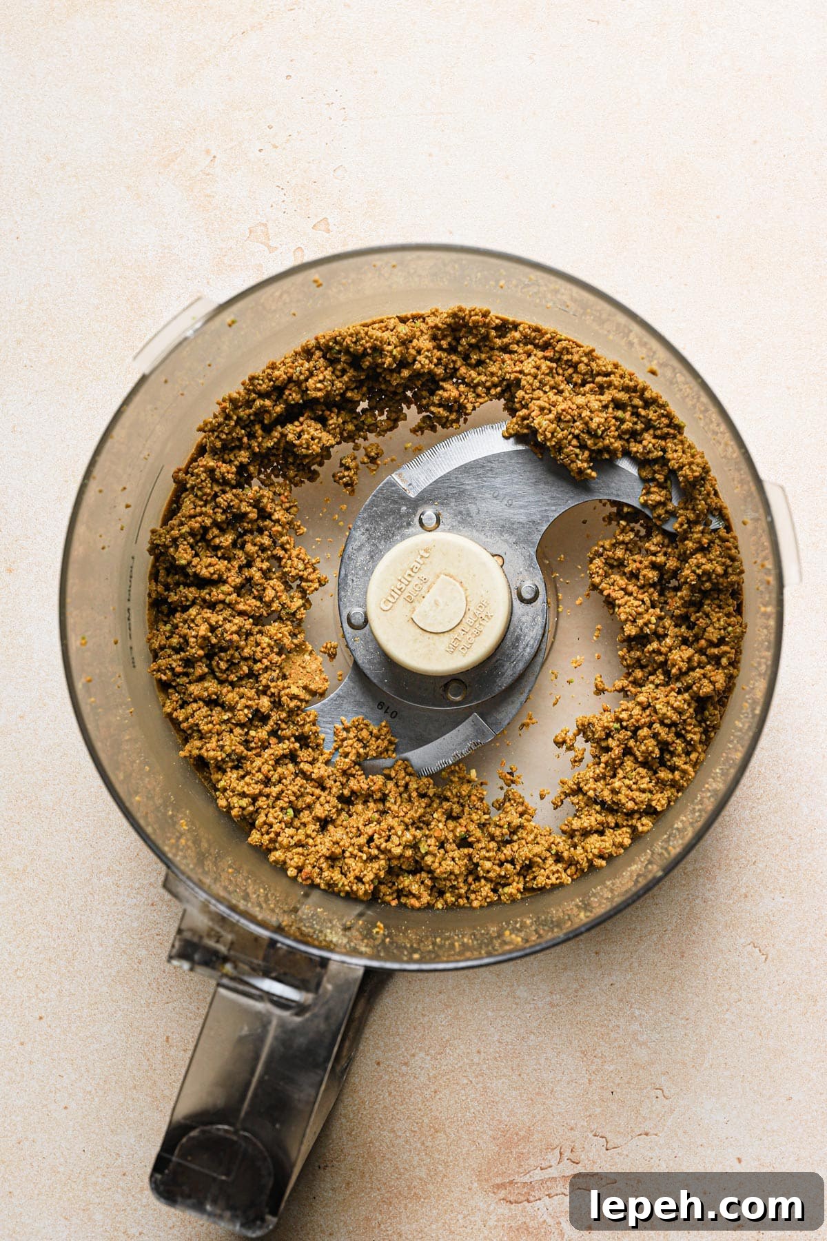 Process half of the pistachio in a food processor until moist and paste like.