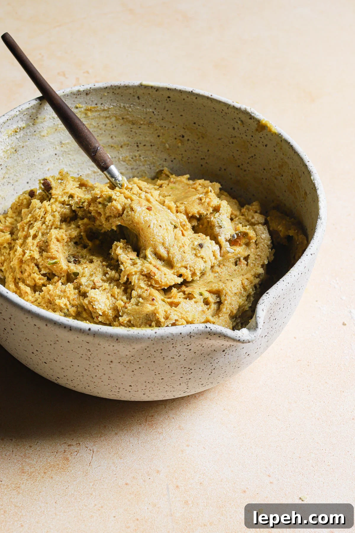 Muffin batter in a bowl with a spoon.