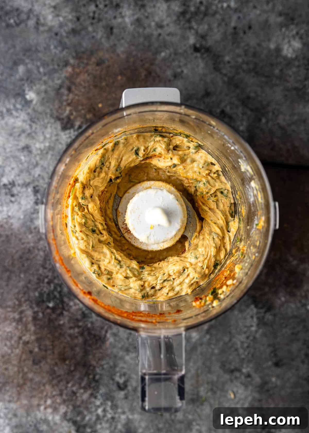 overhead process shot: ingredients for cowboy butter in a blender after blending again with additional spices and butter