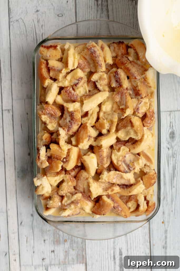 custard and cinnamon rolls in a glass baking dish