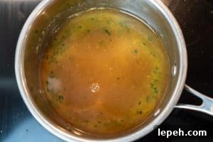 Adding the vegetable stock and soy sauce