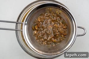 Pouring the gravy through the sieve