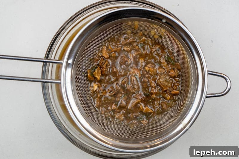 Pouring the gravy through the sieve