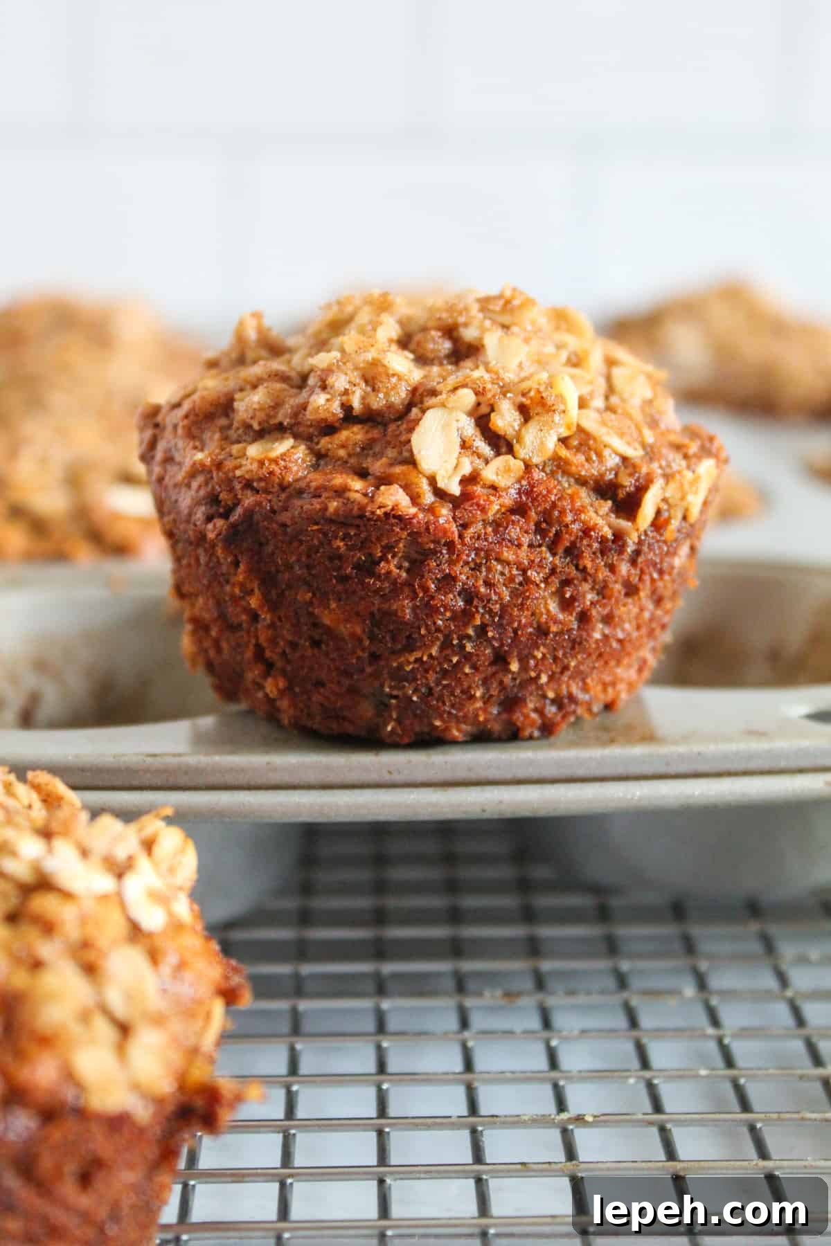 banana oatmeal muffin sitting on a muffin tin.