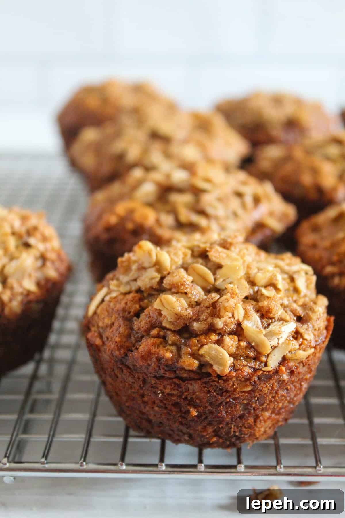 banana oatmeal muffin sitting on a wire rack.