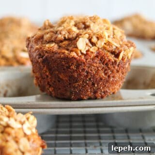 banana oatmeal muffin sitting on a muffin tin.